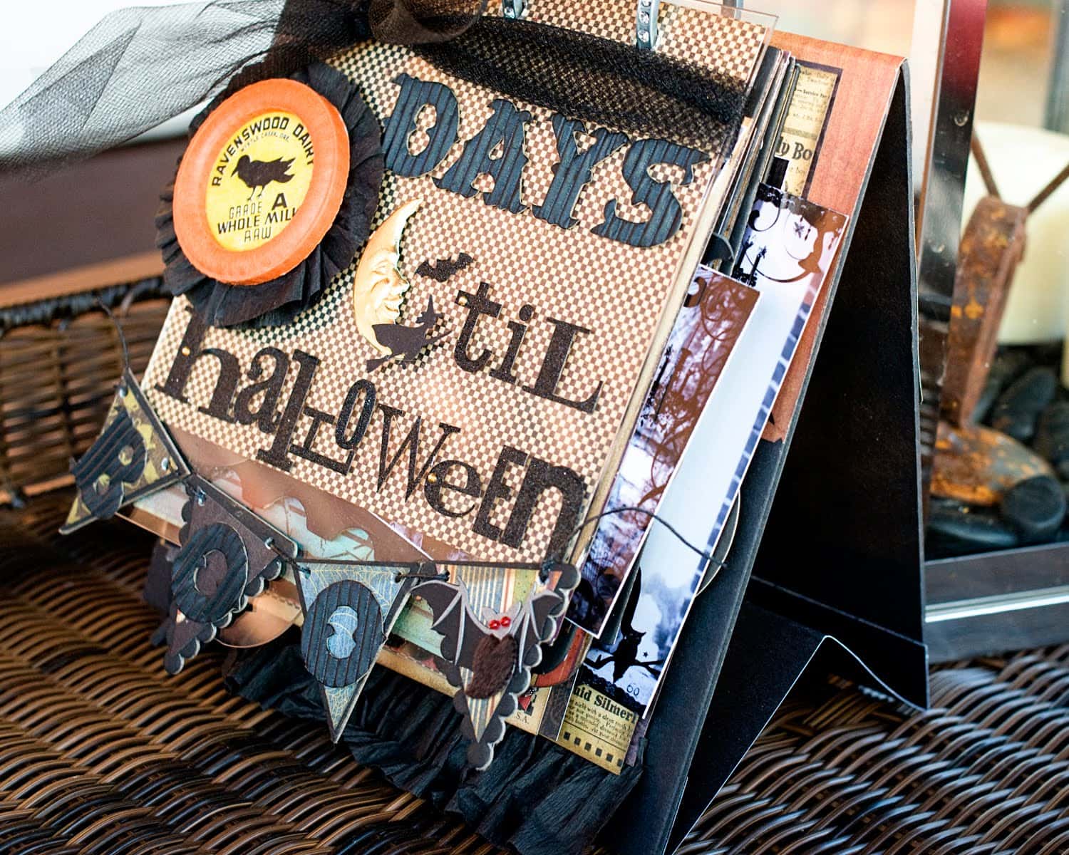 Collage style flip book scrapbook halloween album in black and orange on table