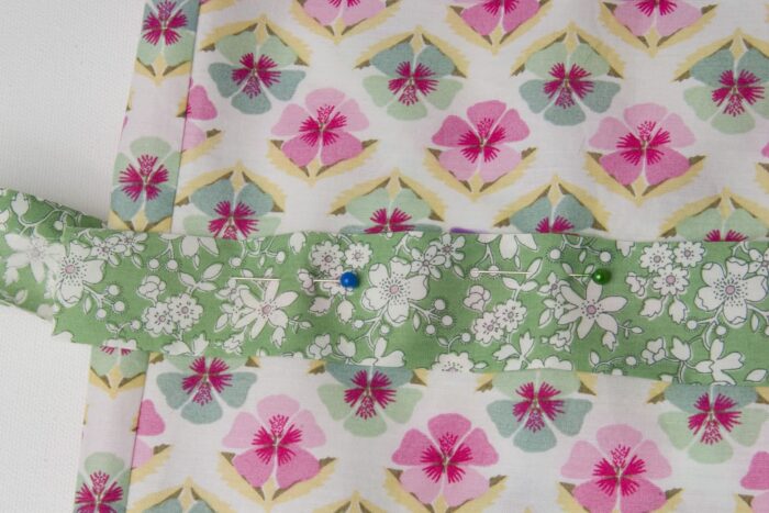 green fabric on floral fabric on white table