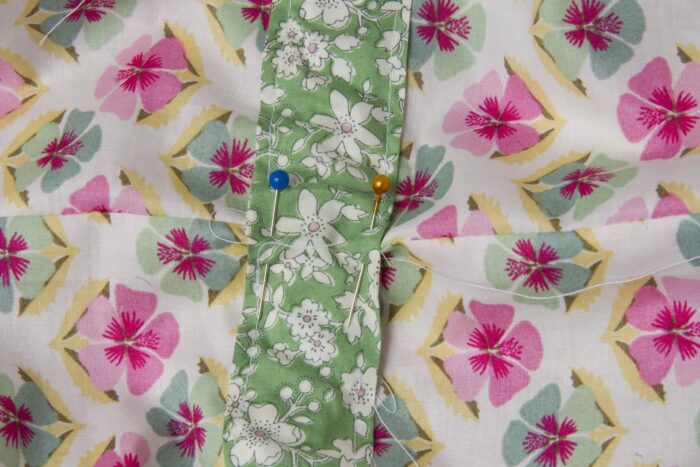 green fabric on floral fabric on white table