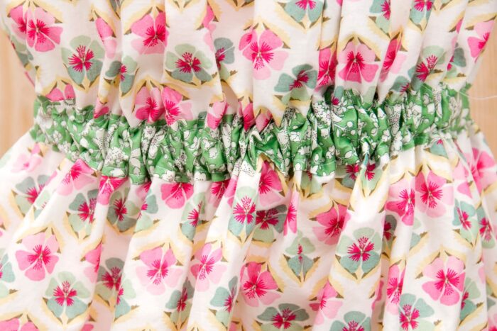 green fabric on floral fabric on white table