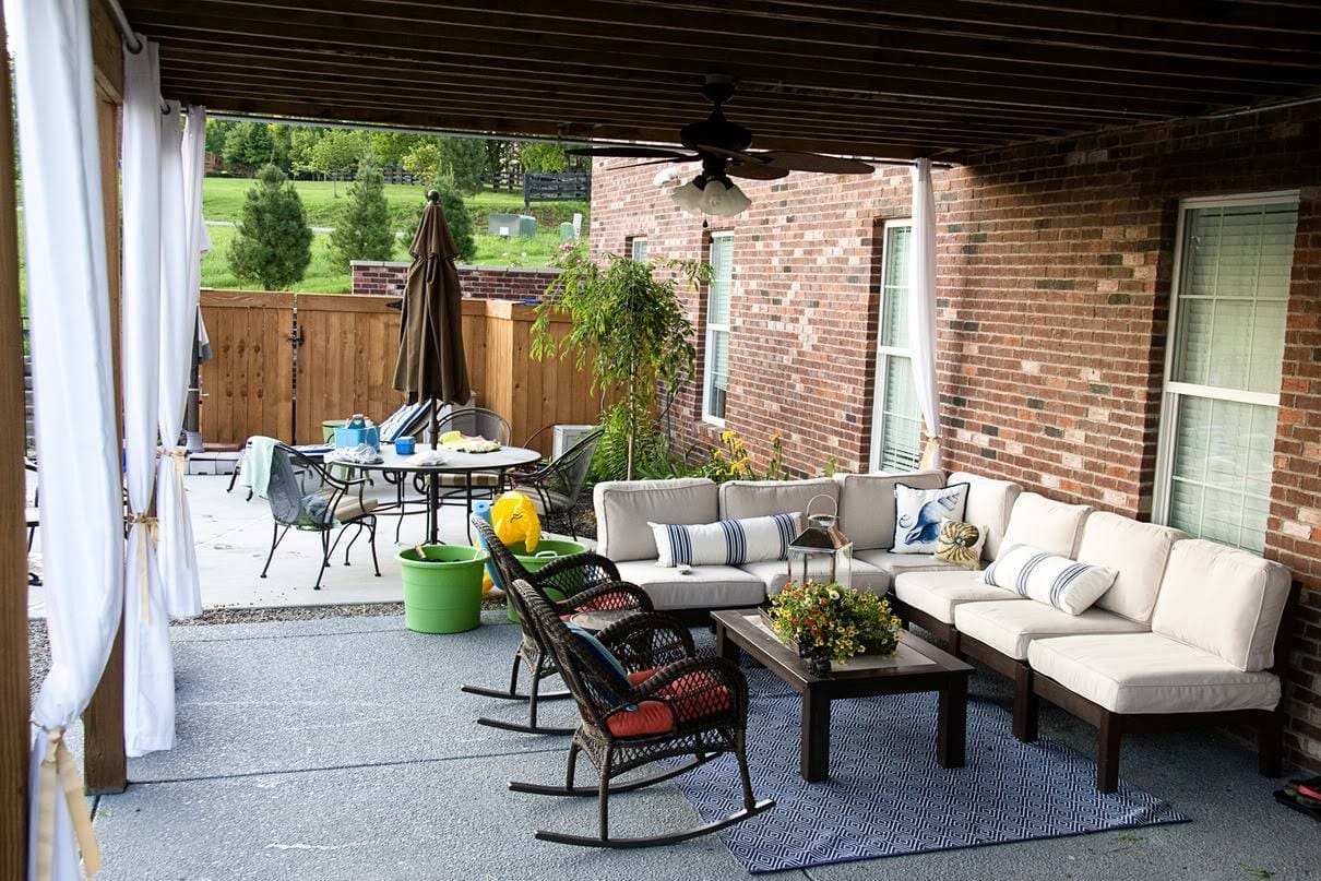 Outdoor patio with curtains and furniture