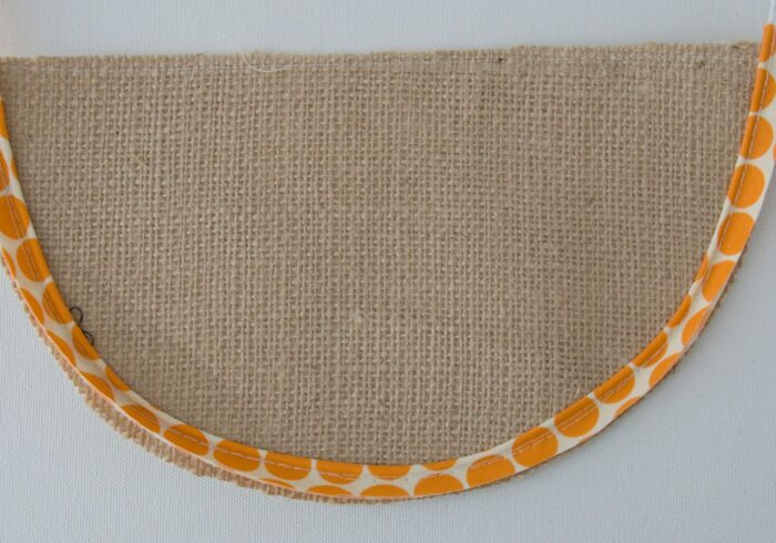 orange piping sewn to brown fabric