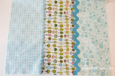 3 pieces of colorful quilt fabric on white table