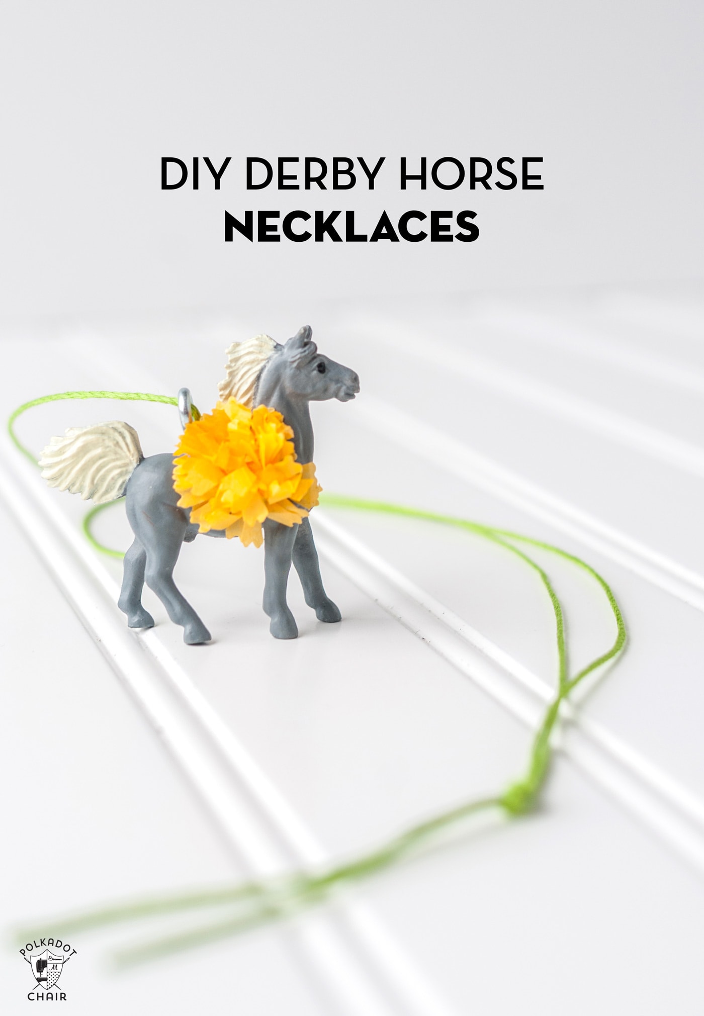 plastic horses on a table with paper flowers and green string
