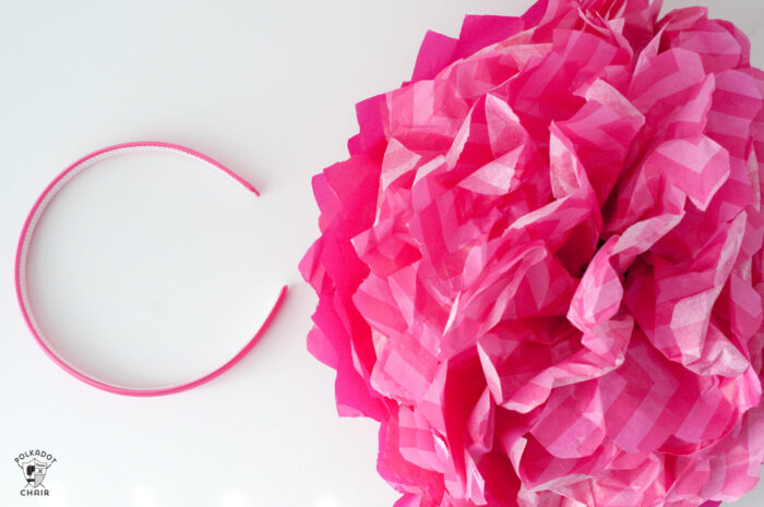 pink flower and headband on white table