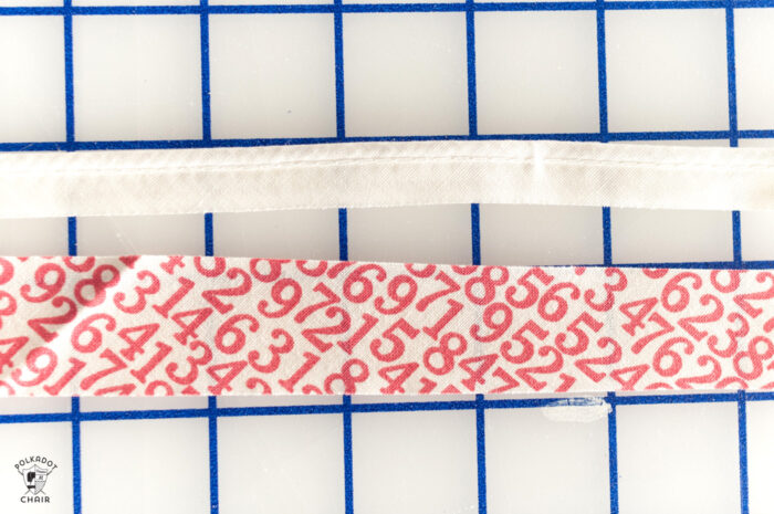 sewn red and white piping on white cutting mat