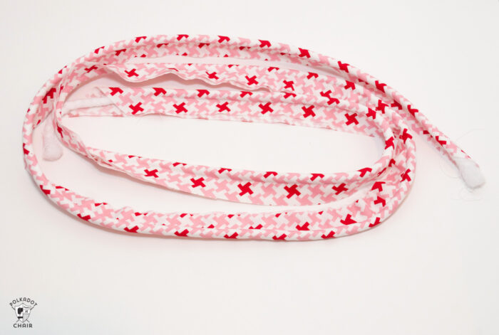 red and white fabric on white cutting mat