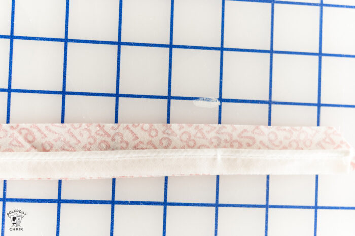 sewn red and white piping on white cutting mat