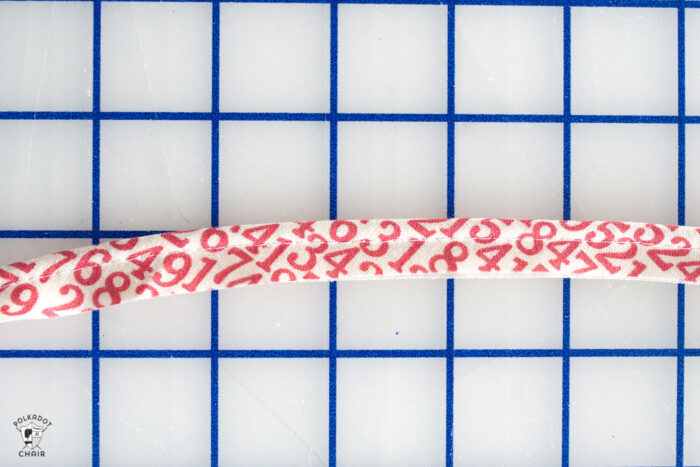 sewn red and white piping on white cutting mat