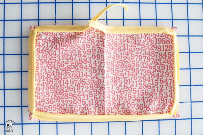 red and white fabric on white cutting mat