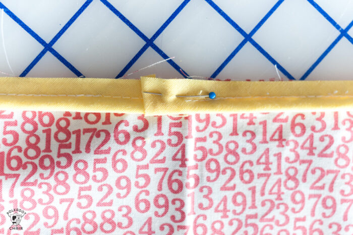 red and white fabric on white cutting mat