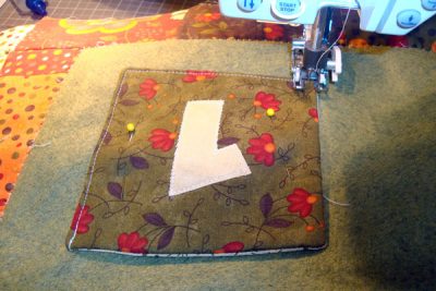 Fabric numbers being sewn on sewing machine