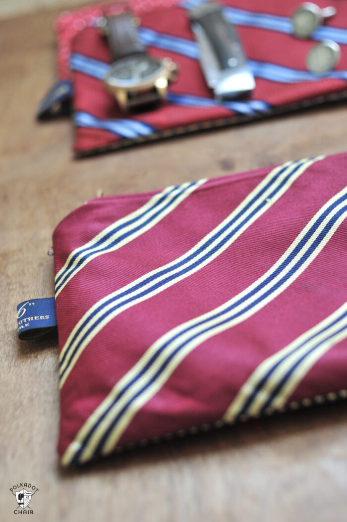 Upcycled neck tie zip pouch on brown table