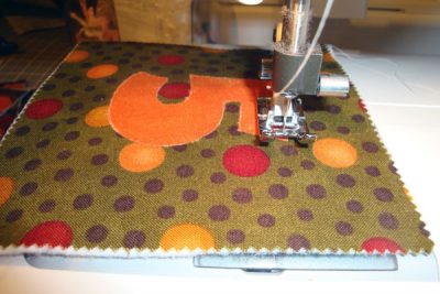Fabric being sewn on sewing machine