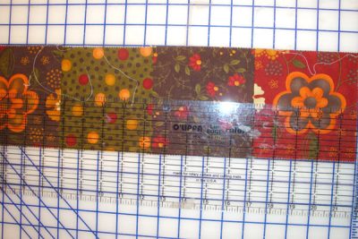 Quilting ruler on top of fabric