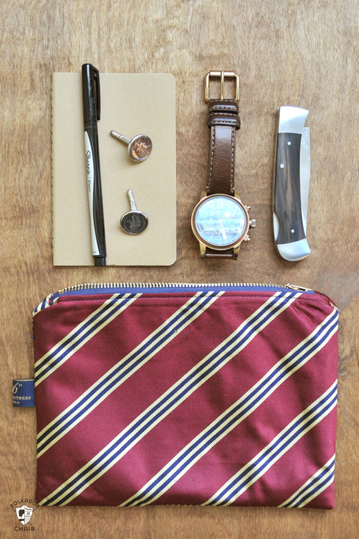 Upcycled neck tie zip pouch on brown table