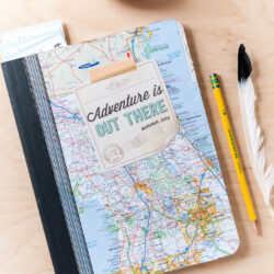 kids composition notebook with map cover on wood table