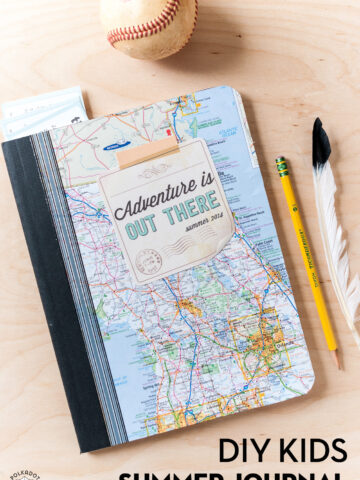 kids composition notebook with map cover on wood table