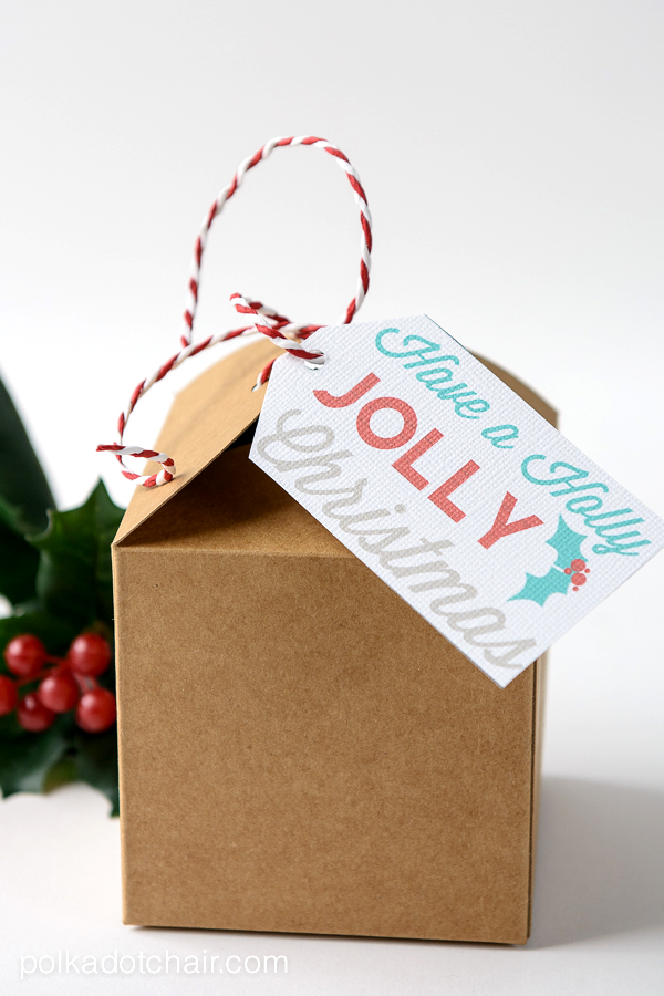 A close up of a box with a holly jolly christmas tag