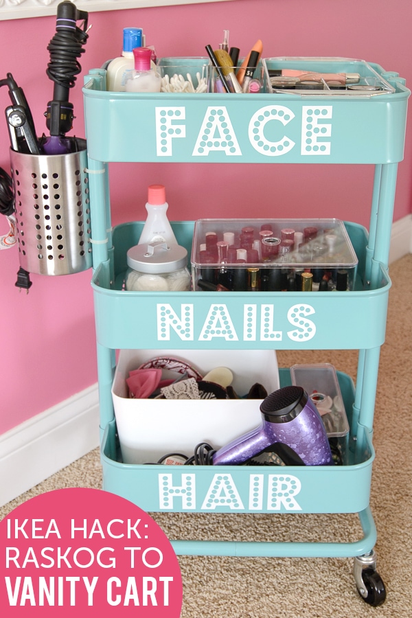 Blue IKEA Raskog Hack, a DIY Rolling Vanity. White vinyl letters spell out face nails and hair on the three shelves. 