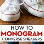 Monogrammed Converse sneakers on floor