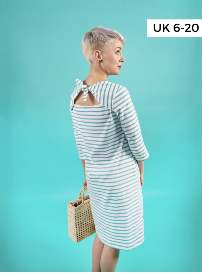 woman in striped dress on blue background