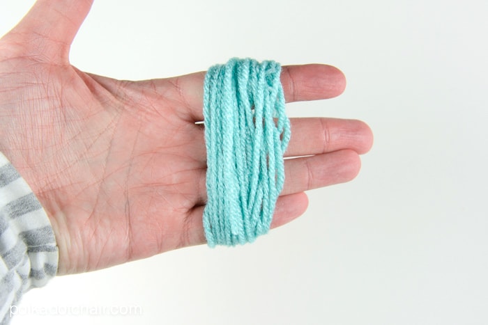 How to make a mini tassel that attaches to a zipper out of yarn -