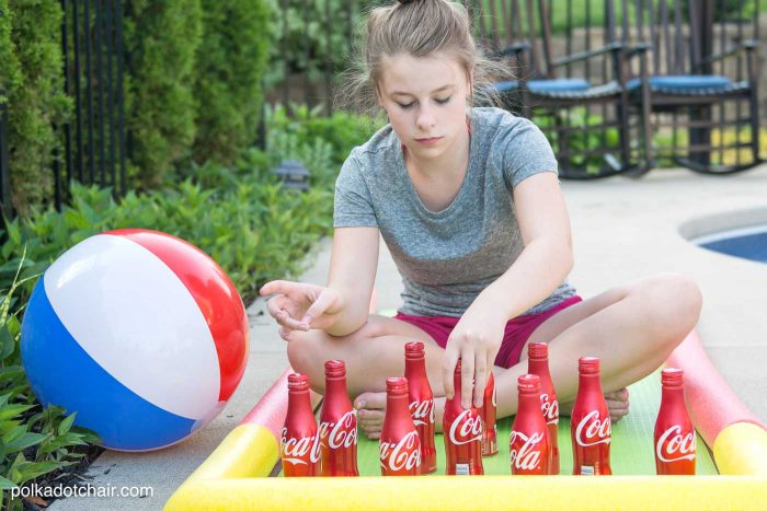 DIY Outdoor Bowling Game, made using Coke bottles, a yoga mat and pool noodles!!