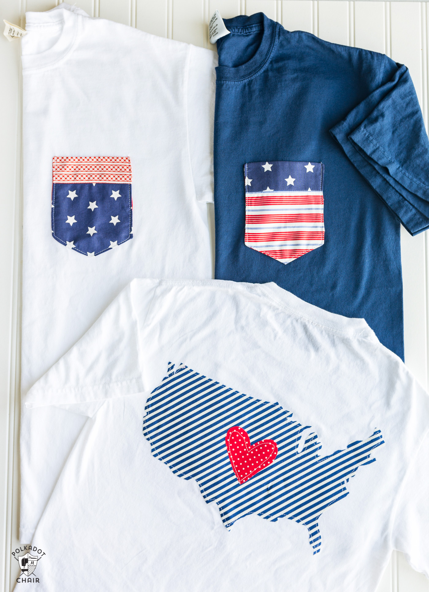 Multiple Fourth of July themed t-shirts on white table.