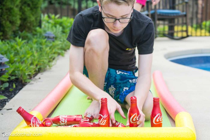 DIY Outdoor Bowling Game, made using Coke bottles, a yoga mat and pool noodles!!