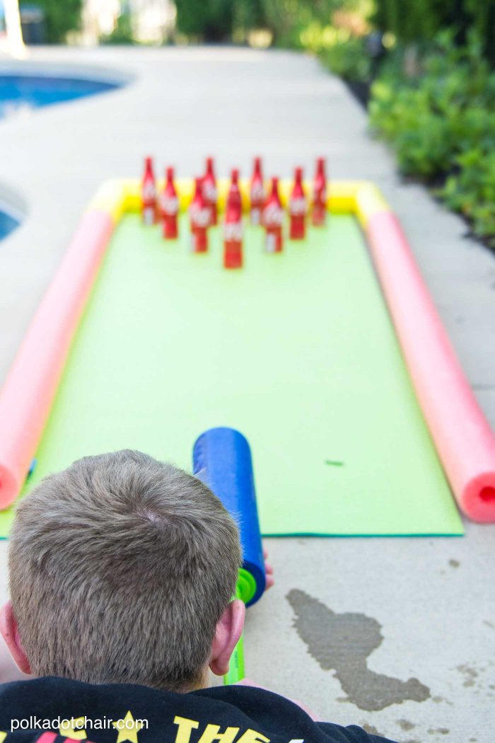 DIY Outdoor Bowling Game, made using Coke bottles, a yoga mat and pool noodles!!