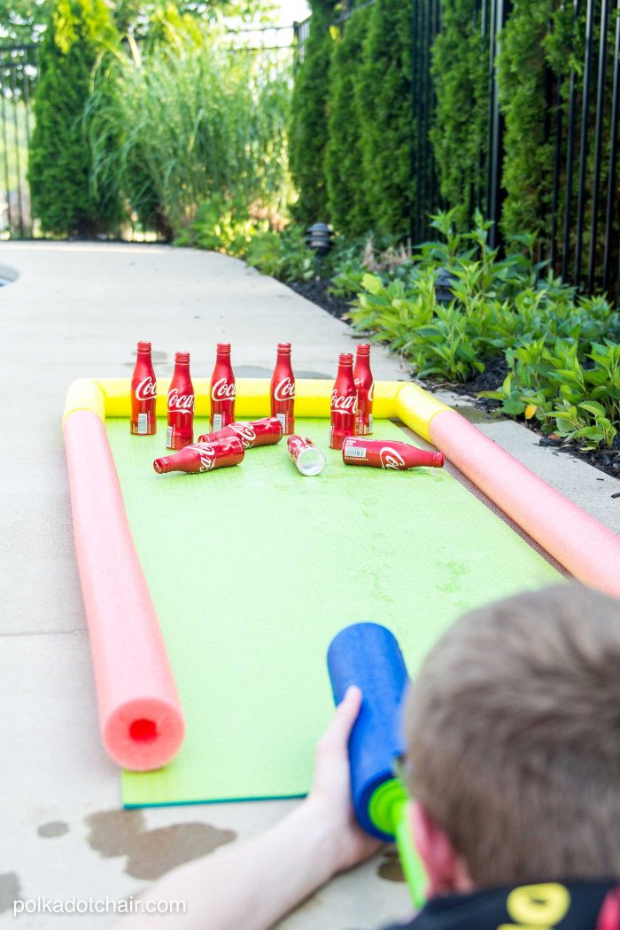 DIY Outdoor Bowling Game, made using Coke bottles, a yoga mat and pool noodles!!