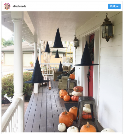 Instagram screen shot of witch hat luminaires on a front porch with pumpkins. 