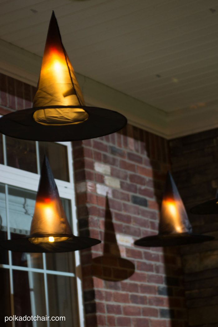 Clever decorating idea for a porch for Halloween, floating Witch's hat luminaries, they even light up at night!