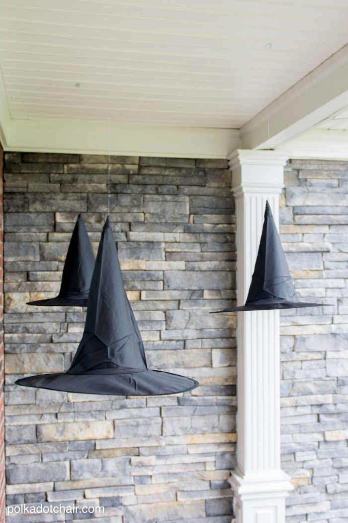 Clever decorating idea for a porch for Halloween, floating Witch's hat luminaries, they even light up at night!