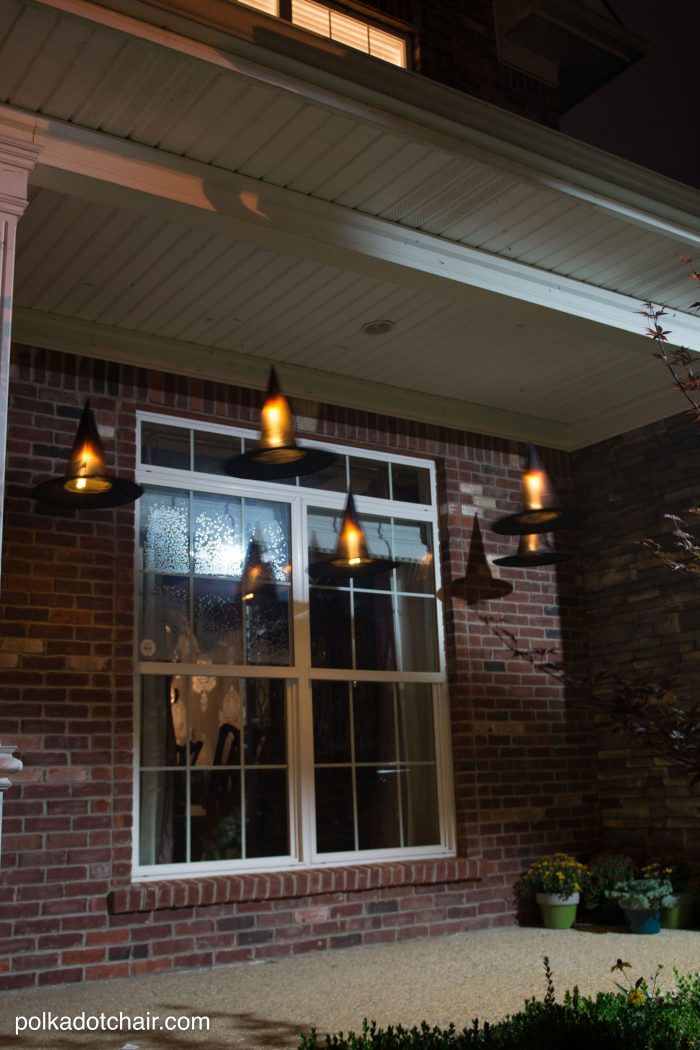 Clever decorating idea for a porch for Halloween, floating Witch's hat luminaries, they even light up at night!