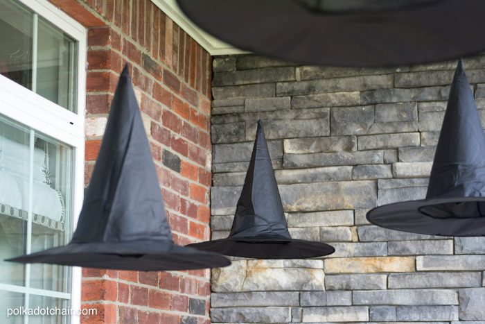 Clever decorating idea for a porch for Halloween, floating Witch's hat luminaries, they even light up at night!