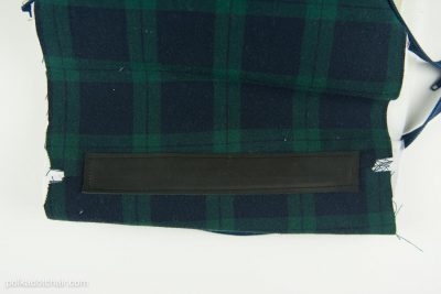 Leather being added to fabric bag.