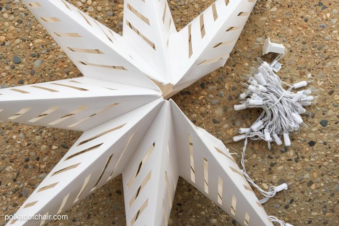 How to hang Star Luminaires on your front porch- what a clever idea for decorating your porch for Christmas