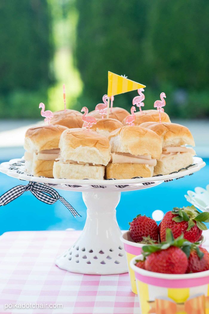 Lots of fun ideas to throw a backyard flamingo themed pool party, including free printable silverware containers and a recipe for pineapple and mango virgin pina coladas 