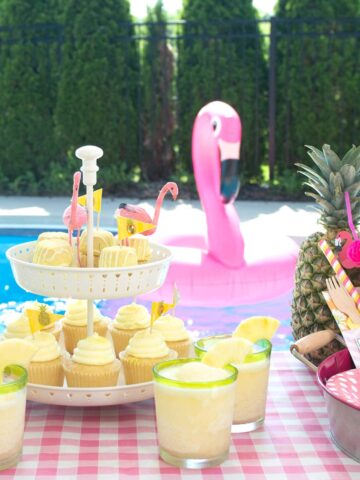 Lots of fun ideas to throw a backyard flamingo themed pool party, including free printable silverware containers and a recipe for pineapple and mango virgin pina coladas