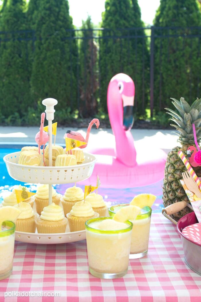 Lots of fun ideas to throw a backyard flamingo themed pool party, including free printable silverware containers and a recipe for pineapple and mango virgin pina coladas 