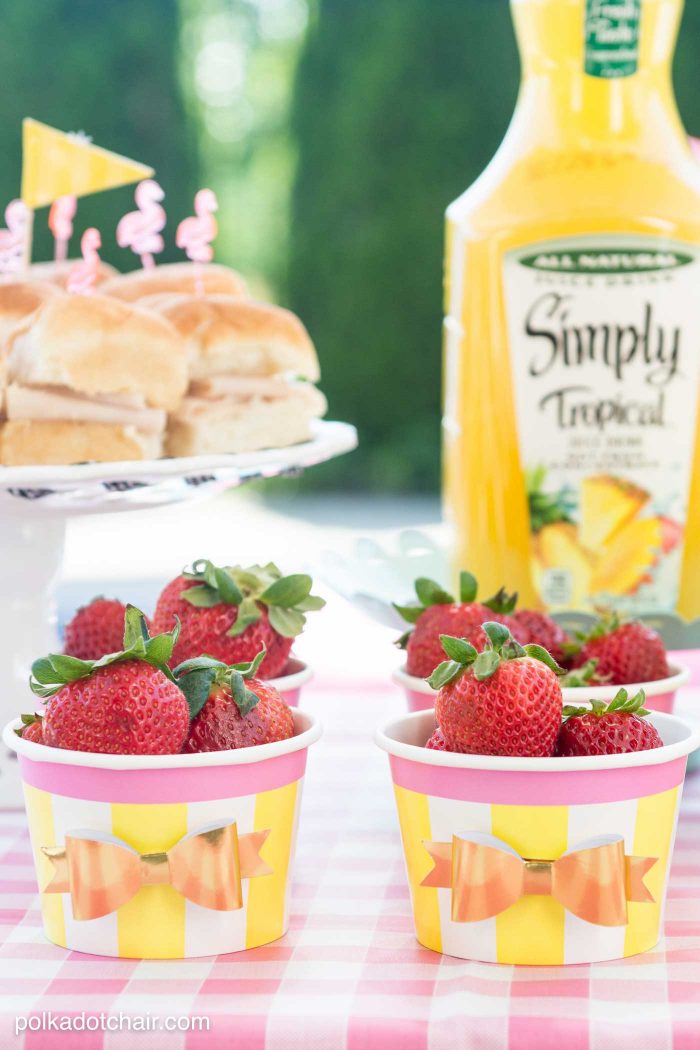 Lots of fun ideas to throw a backyard flamingo themed pool party, including free printable silverware containers and a recipe for pineapple and mango virgin pina coladas 