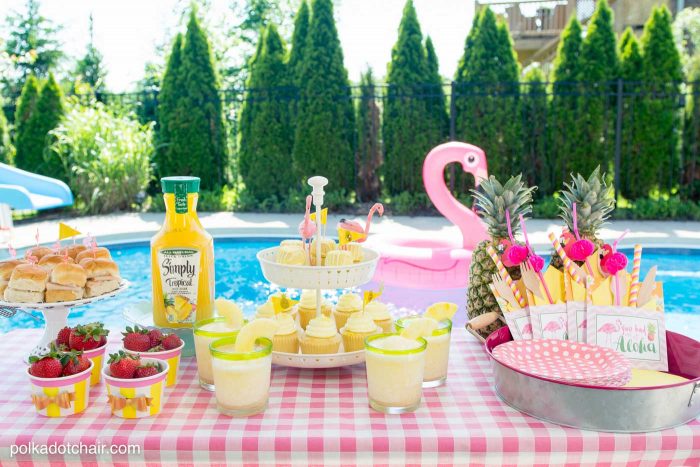 Lots of fun ideas to throw a backyard flamingo themed pool party, including free printable silverware containers and a recipe for pineapple and mango virgin pina coladas