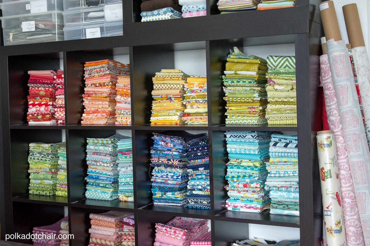 Black shelves with colored fabrics inside