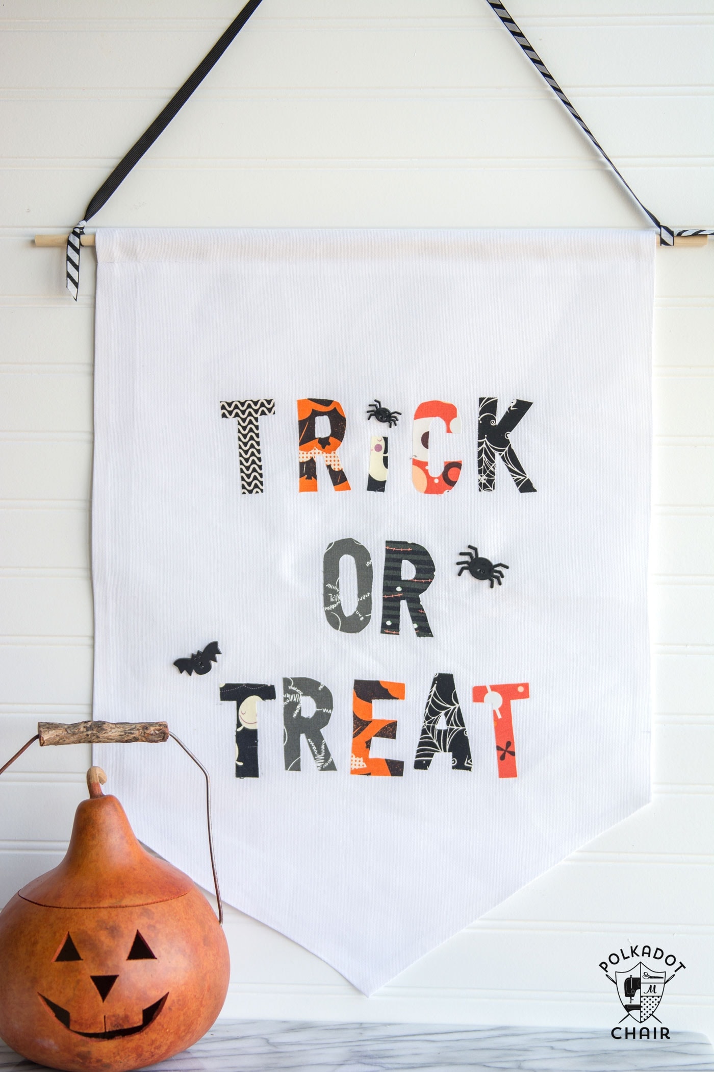 DIY Trick or Treat Halloween Banner- in black and white with wood pumpkin on wall