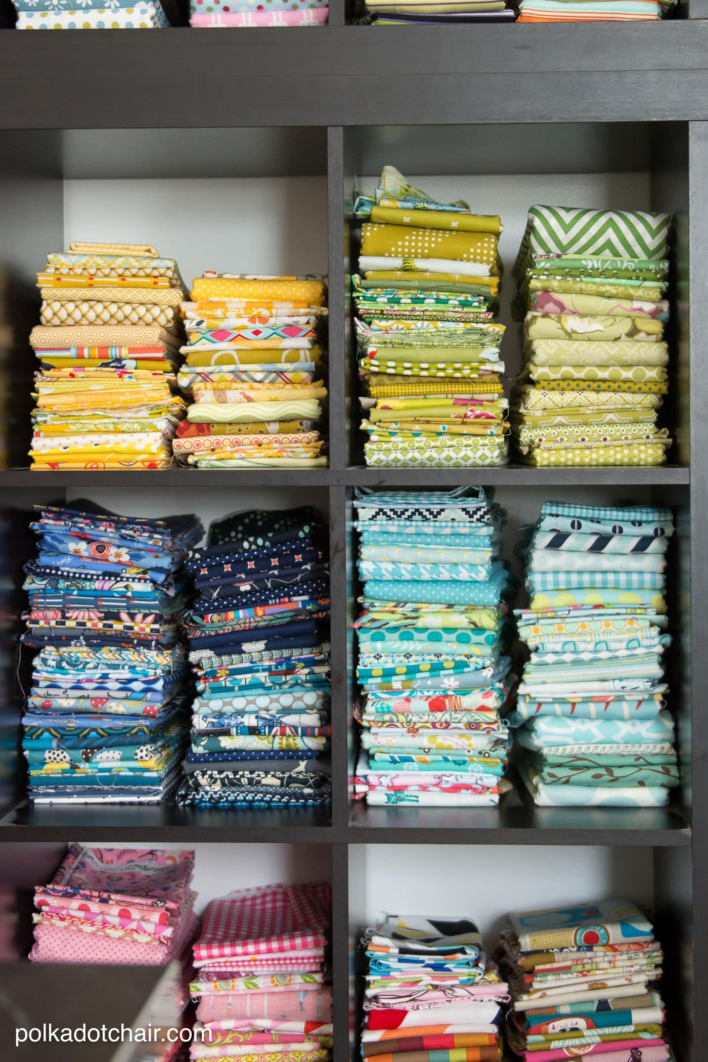 Black bookshelves with colored fabrics inside