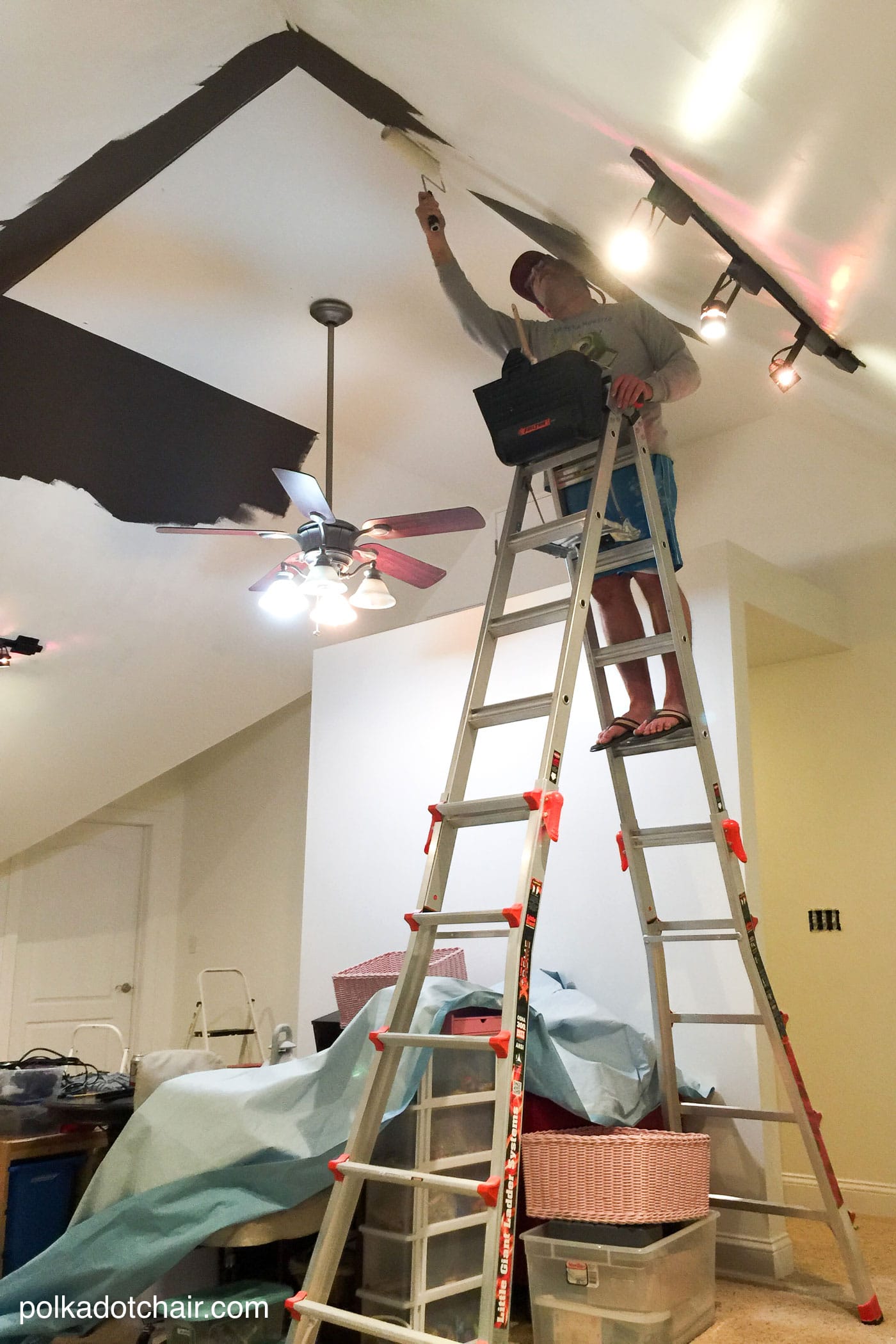 man painting celling white