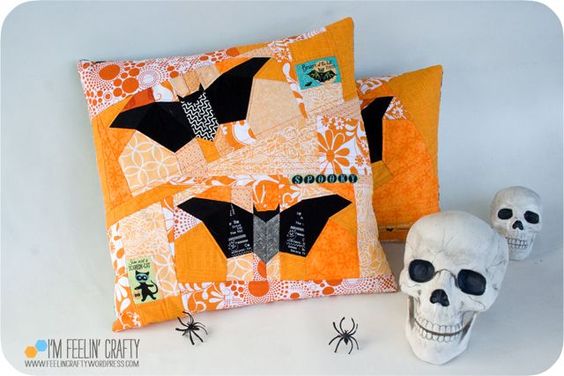 Orange and black halloween pillows on white countertop