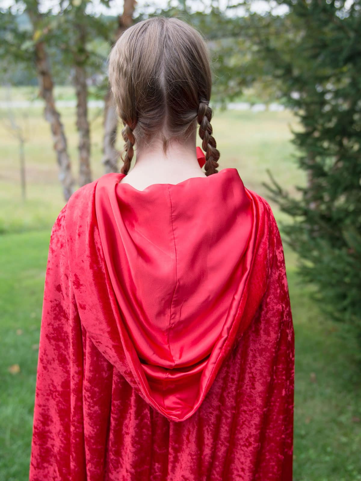 Back view of model wearing red cape